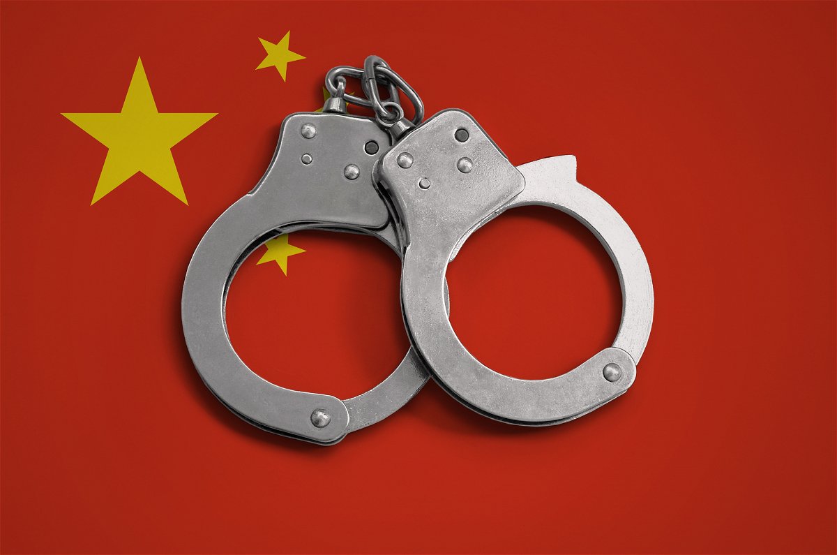 china flag and police handcuffs. the concept of observance of the law in the country and protection from crime